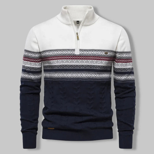 Navy and white sweater with patterned sleeves on a gray background
