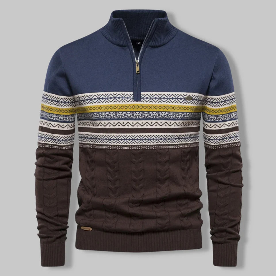 Navy and brown sweater with patterned sleeves on a gray background