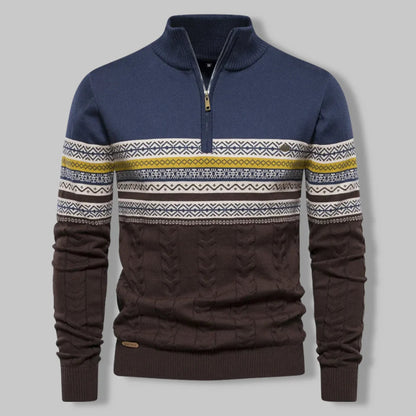 Navy and brown sweater with patterned sleeves on a gray background