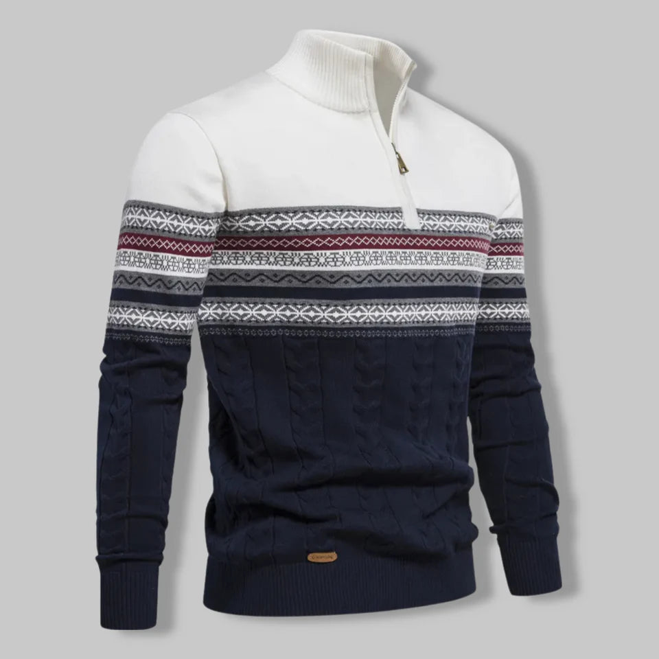 Navy and white patterned sweater on a gray background