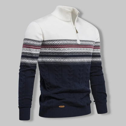 Navy and white patterned sweater on a gray background