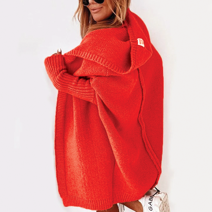 Person wearing a bright red sweater on a white background