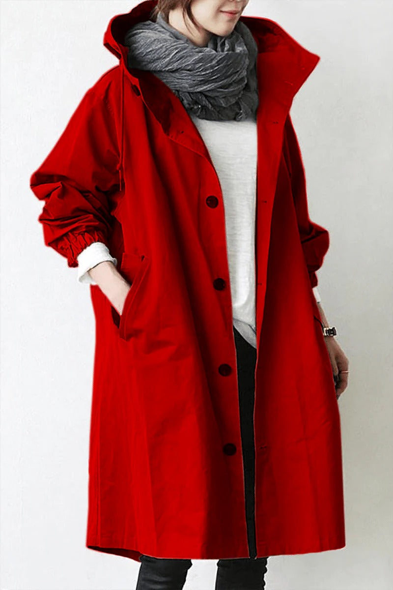 Person wearing a red coat with a hood on a white background