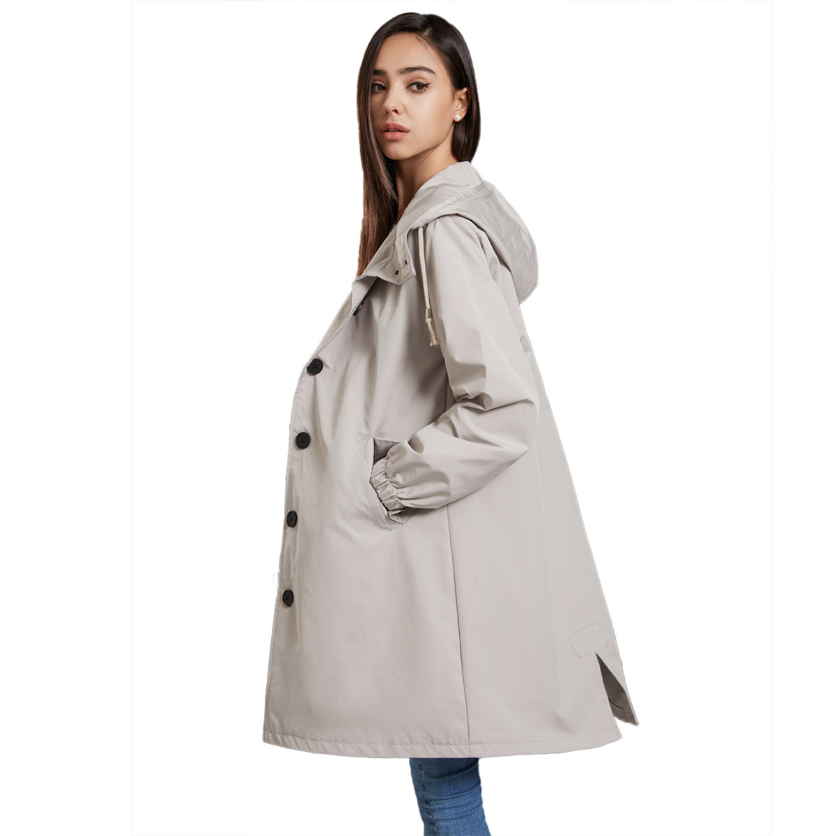 Woman wearing a beige trench coat on a white background