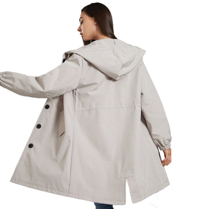 Woman wearing a beige raincoat on a white background