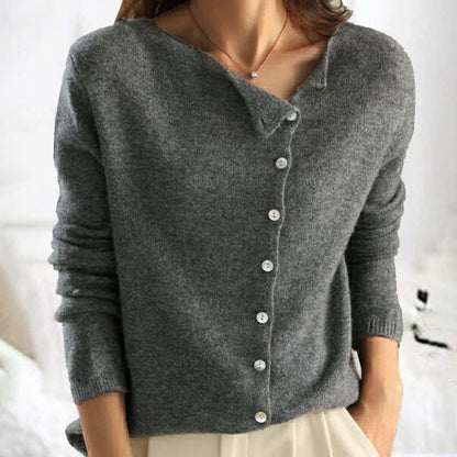 Gray cardigan worn by a person with a blurred background