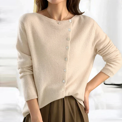Beige cardigan worn by a person on a white background