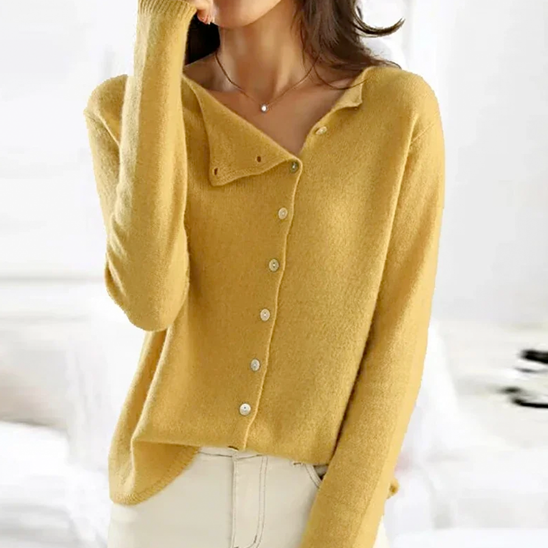 Yellow cardigan worn by a person on a white background