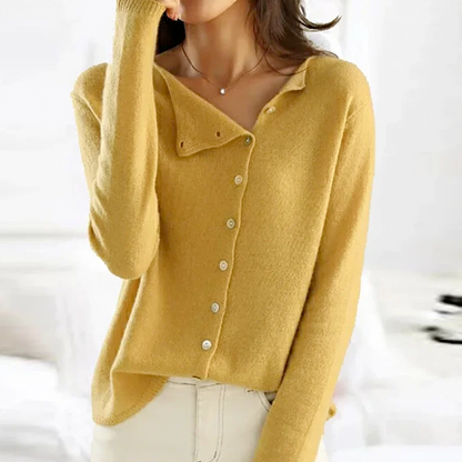 Yellow cardigan worn by a person on a white background