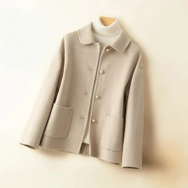 Light gray coat with pearl buttons on a white background