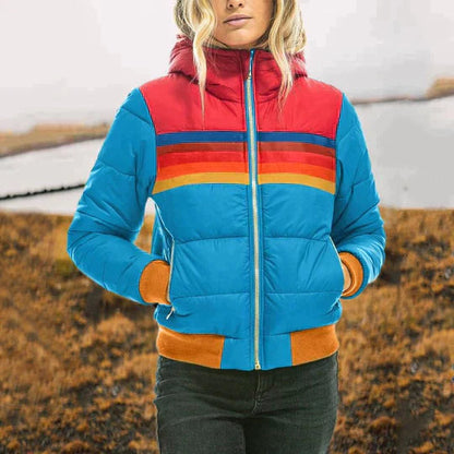Person wearing a colorful puffer jacket with a striped pattern in an outdoor setting.