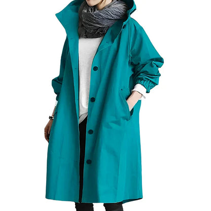 Teal coat worn by a person on a white background