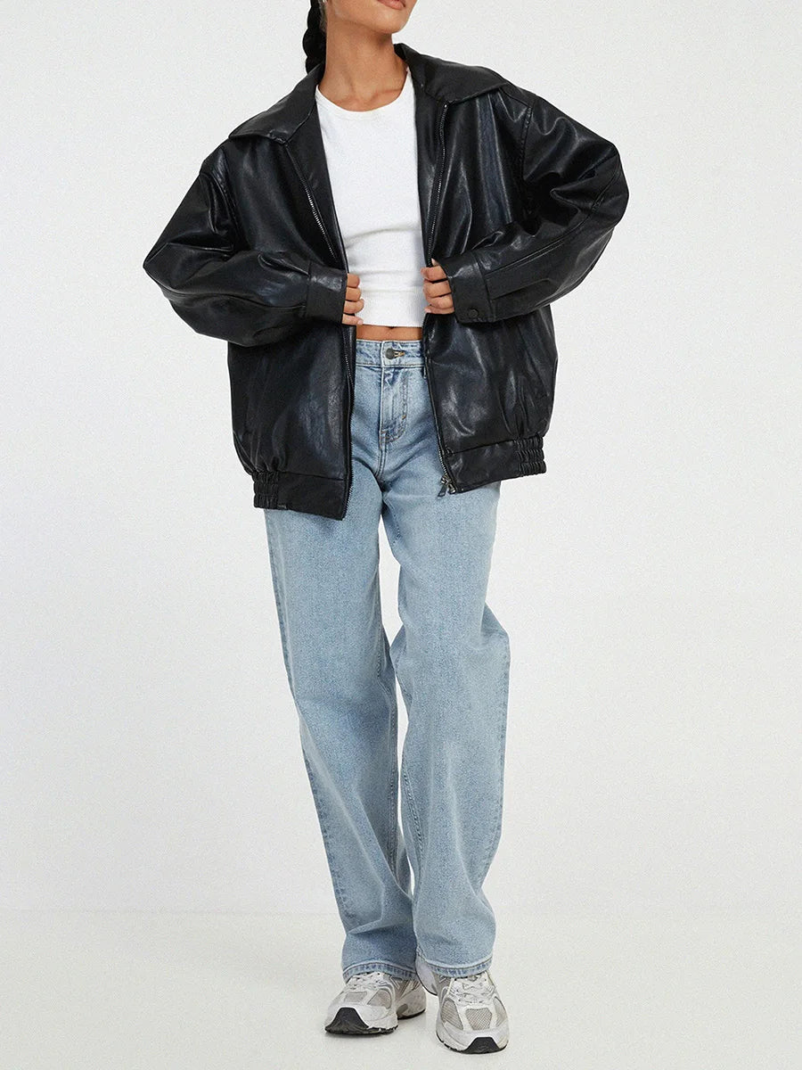 Person wearing a black leather jacket, white shirt, and blue jeans on a white background