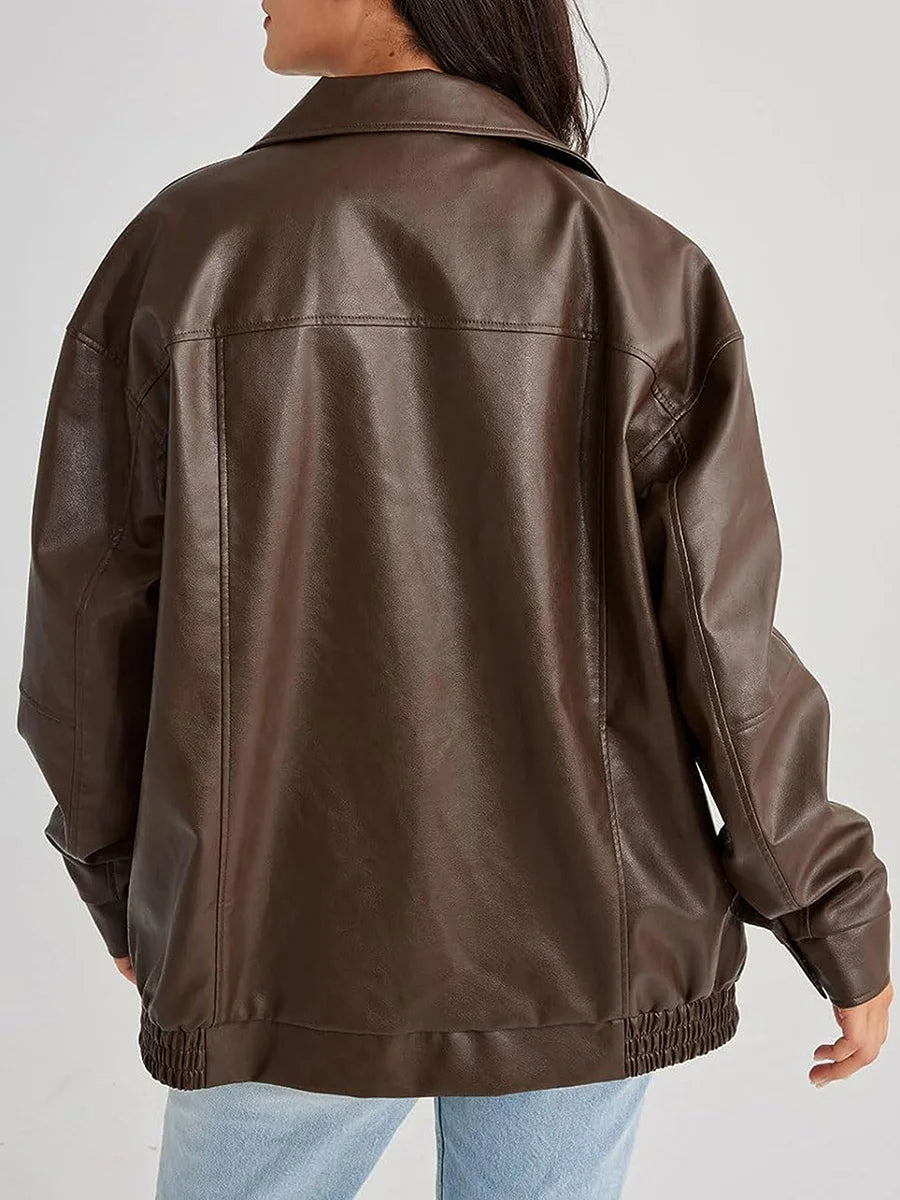 Brown leather jacket worn by a person on a plain background