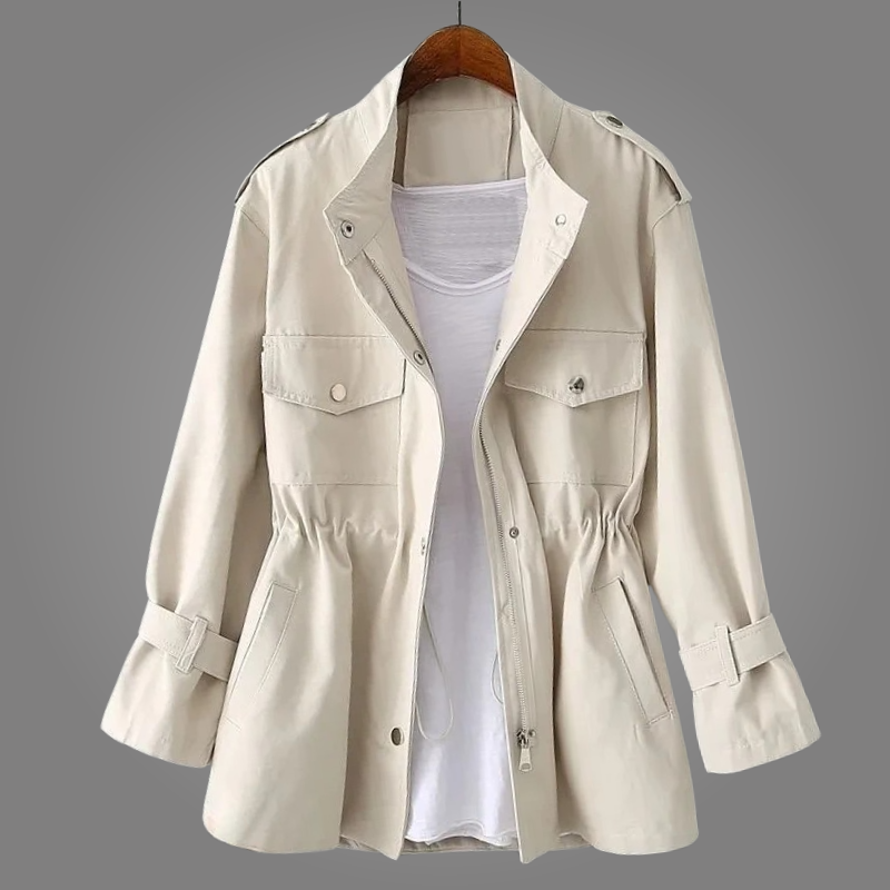 Beige trench coat on a hanger against a gray background