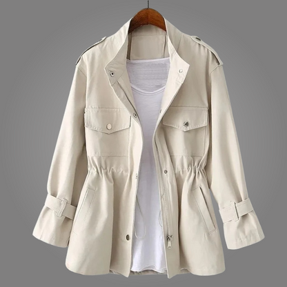 Beige trench coat on a hanger against a gray background