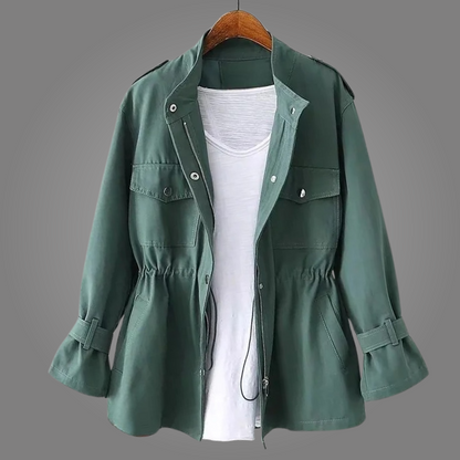 Green jacket on a hanger against a gray background