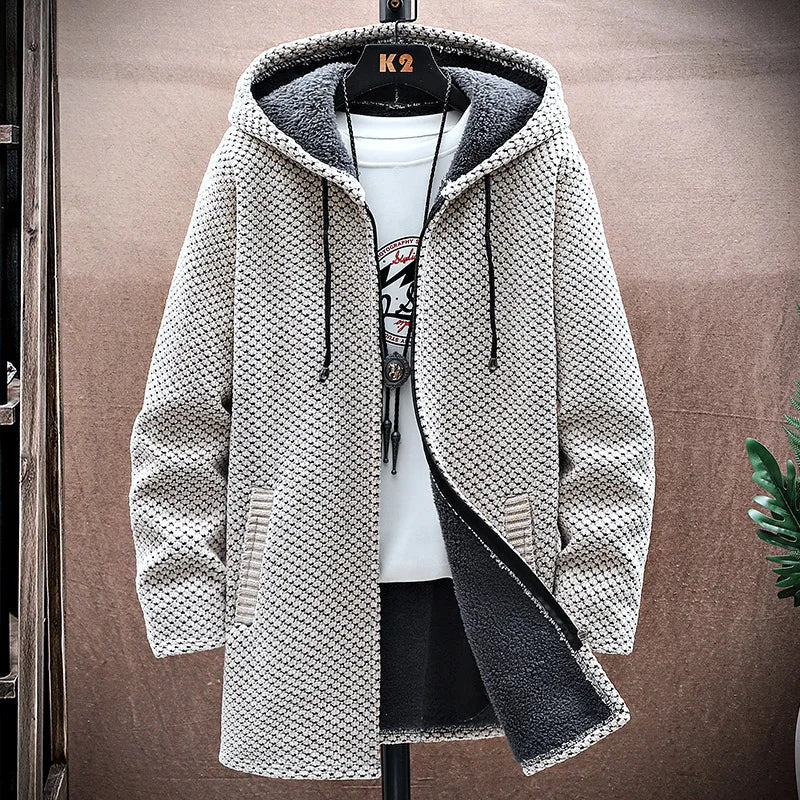 Textured hooded jacket on a hanger against a neutral background