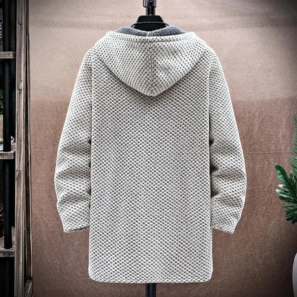 Textured hooded coat on a mannequin against a neutral background