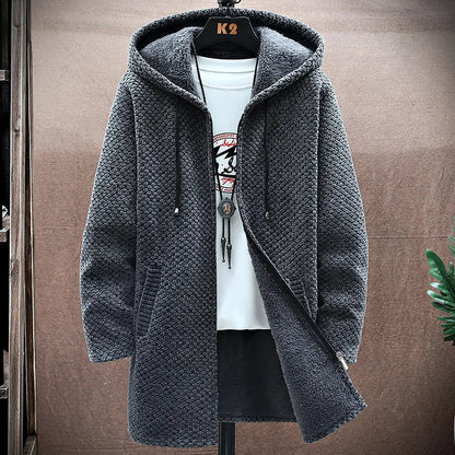 Gray knitted hoodie on a hanger against a brown background