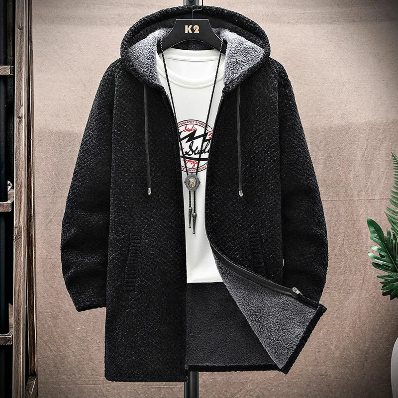 Black hooded jacket with gray lining on a hanger against a neutral background